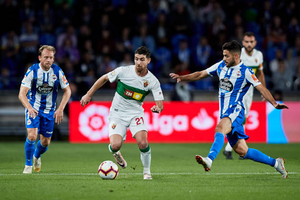LA CORUNA, SPAIN - OCTOBER 12:  Javi Flores of Elche CF is challenged by Carles Gil of Deportivo de La Coruna during the La Liga 123 match between Deportigo de La Coruna and Elche CF at Abanca Riazor Staidum on October 12, 2018 in A Coruna, Spain.  (Photo by Quality Sport Images/Getty Images)